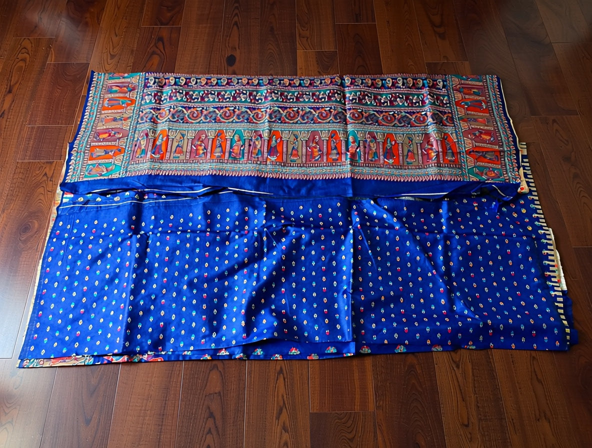 Blue fabric with colorful patterns on a wooden floor